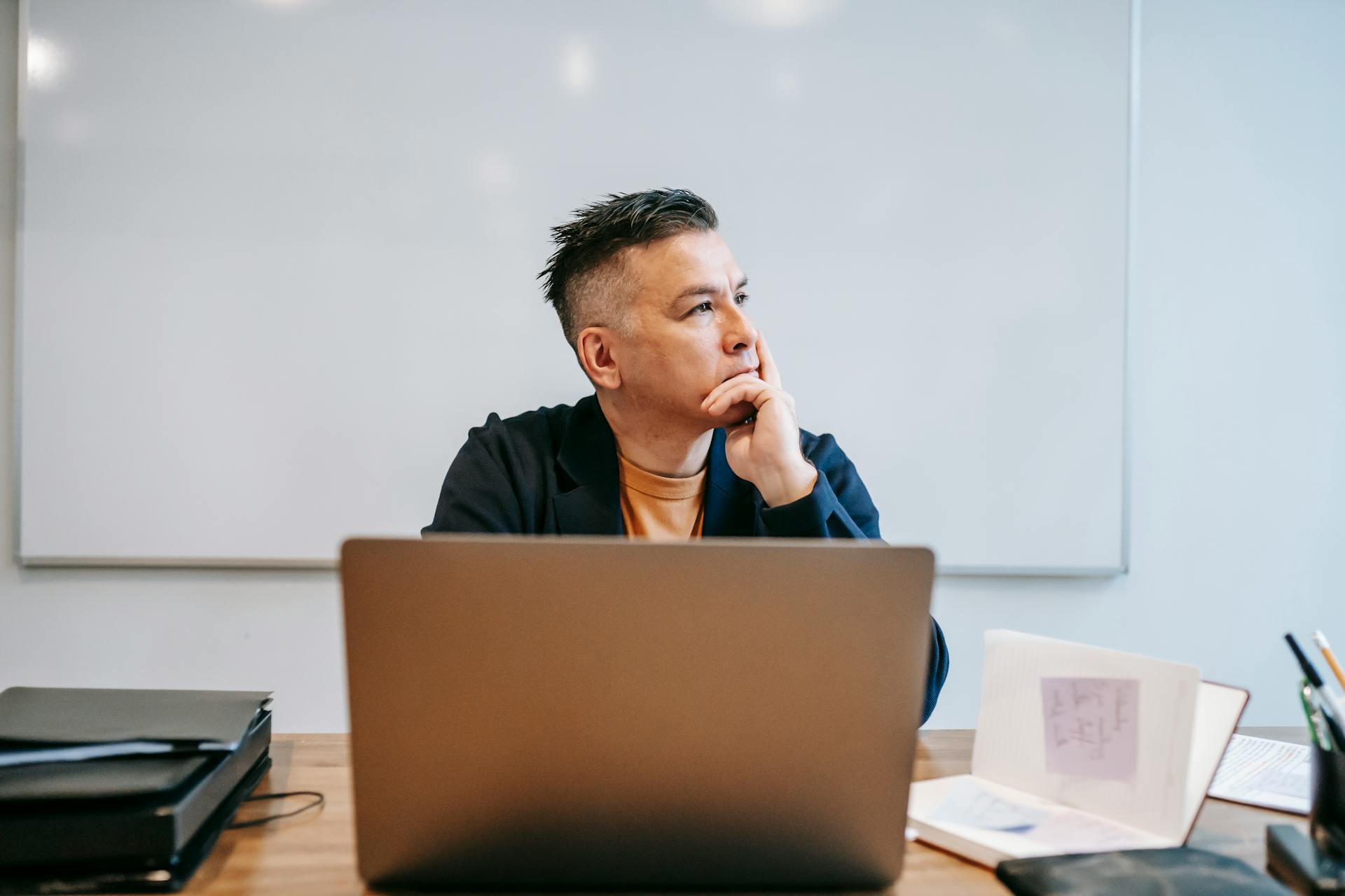 A man looking right with a laptop right in front of him